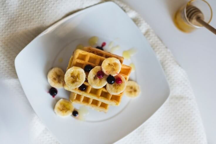 Cooking delicious banana waffles in iron